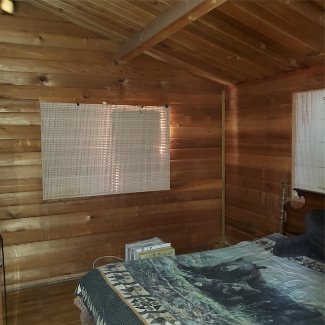 bedroom with lofted ceiling with beams, wooden ceiling, wood finished floors, and wooden walls