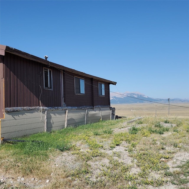 view of side of home featuring a mountain view