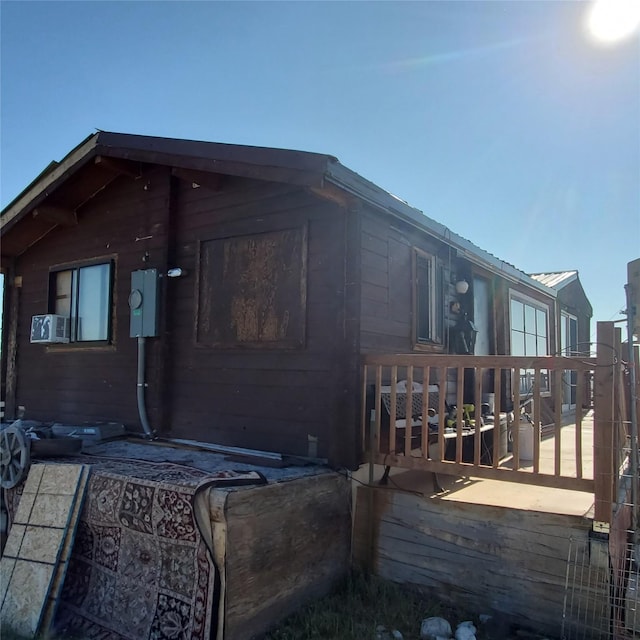 view of home's exterior featuring a wooden deck and metal roof
