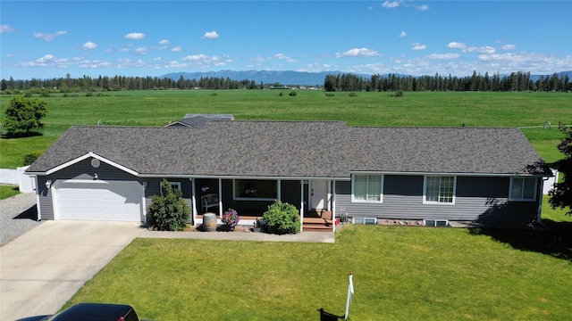 700 Stone St, Kalispell, MT 59901 - ranch-style house featuring an attached garage, concrete driveway, a front yard, and roof with shingles