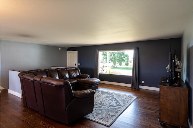 living room with baseboards and dark wood-style flooring