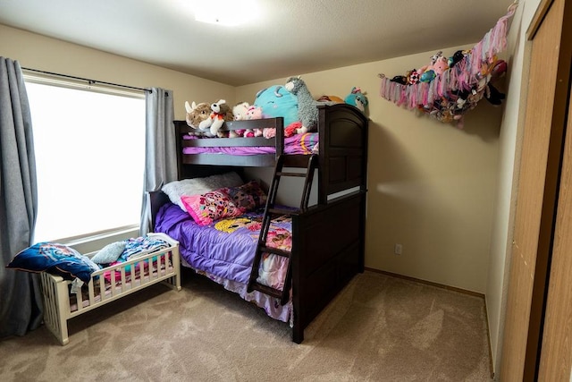 carpeted bedroom with multiple windows