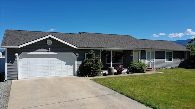 700 Stone St, Kalispell, MT 59901 - single story home with a garage, a front lawn, roof with shingles, driveway, and a porch