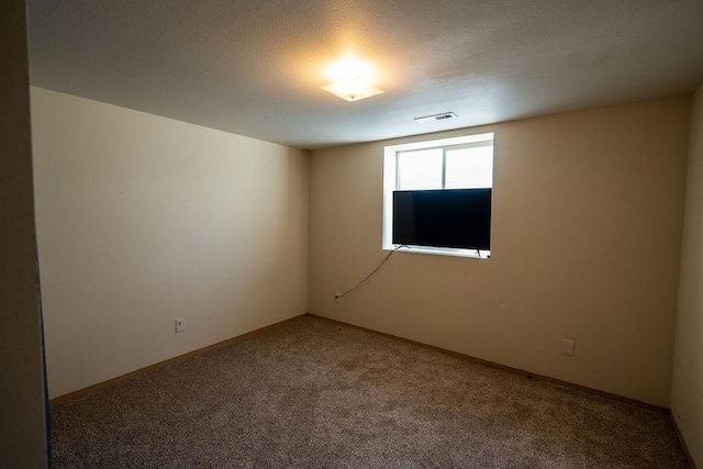 empty room featuring baseboards, carpet, and visible vents