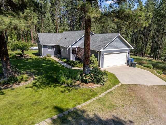 ranch-style house featuring a garage and a front lawn