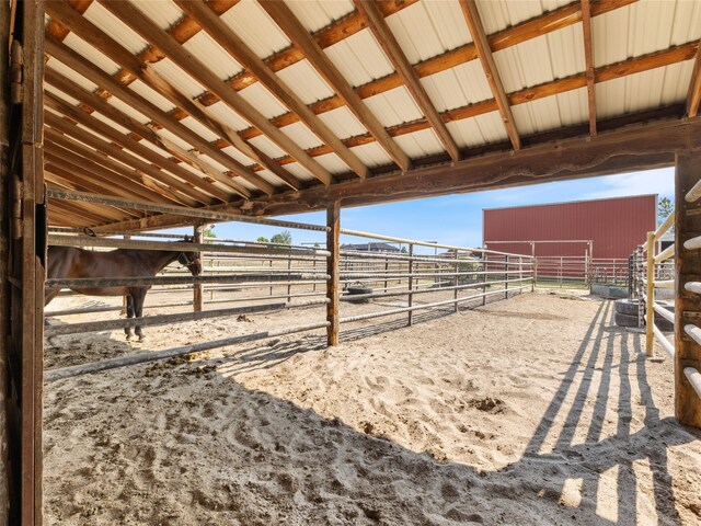 view of stable featuring a rural view