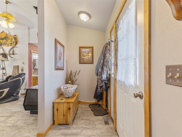 doorway to outside featuring ceiling fan and lofted ceiling