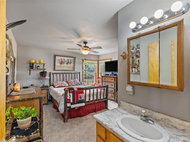 bedroom featuring light carpet, ceiling fan, and sink