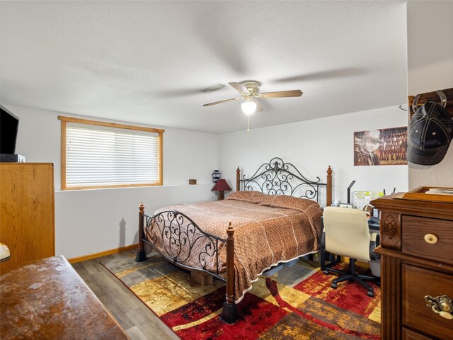 bedroom featuring ceiling fan and hardwood / wood-style flooring