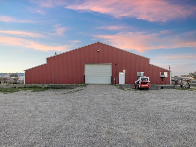 outdoor structure at dusk with a garage