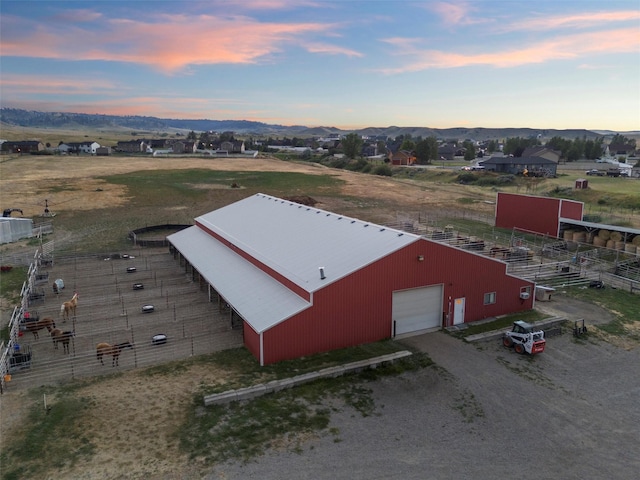 aerial view at dusk featuring a mountain view