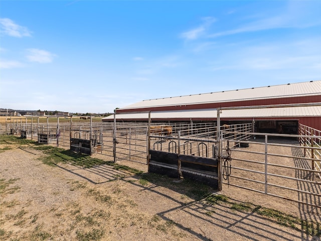 view of horse barn with a rural view