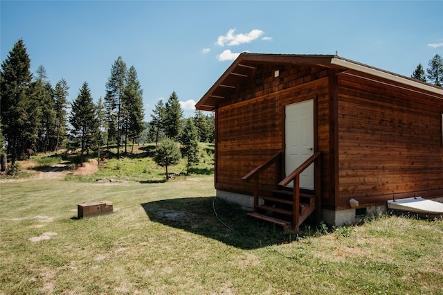 view of outbuilding with a lawn