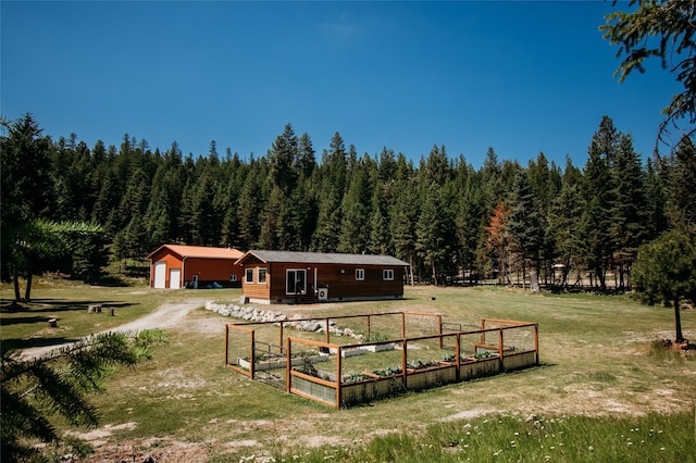 exterior space with a lawn, a rural view, and an outbuilding