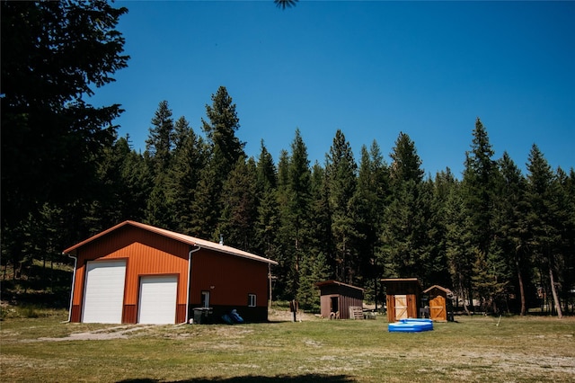 view of yard with a garage and a storage shed