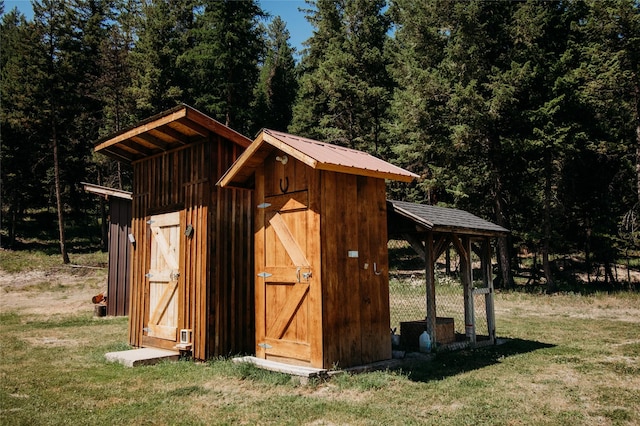 view of outbuilding with a lawn