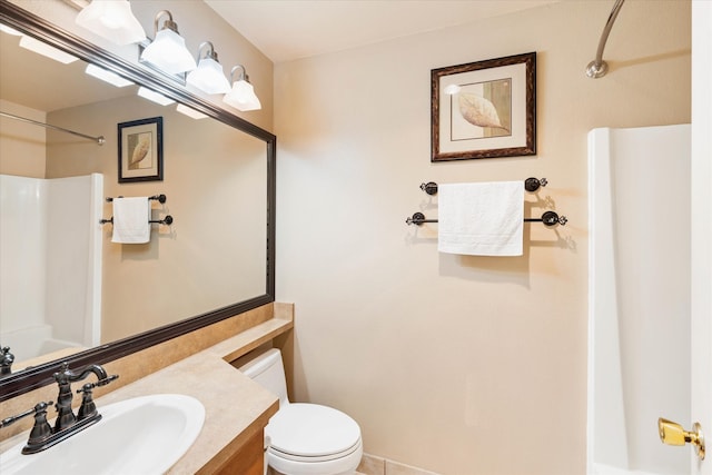 bathroom featuring vanity, toilet, and walk in shower