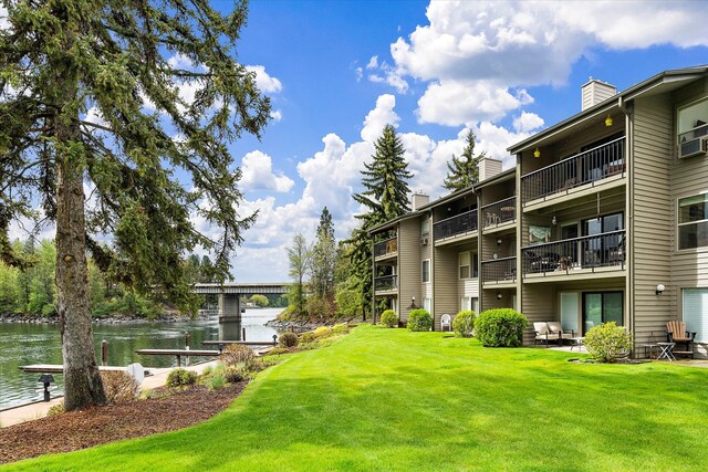 view of home's community with a yard and a water view