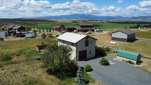 drone / aerial view featuring a rural view and a mountain view