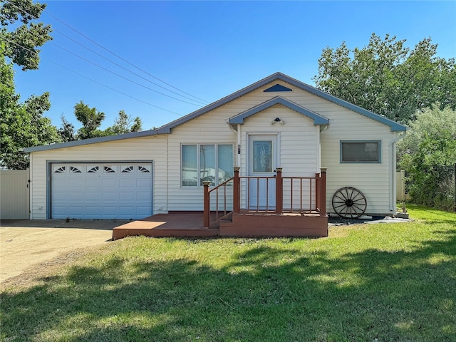 view of front of property with an attached garage, driveway, and a front lawn