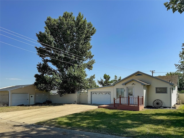 ranch-style house featuring an attached garage, driveway, and a front lawn