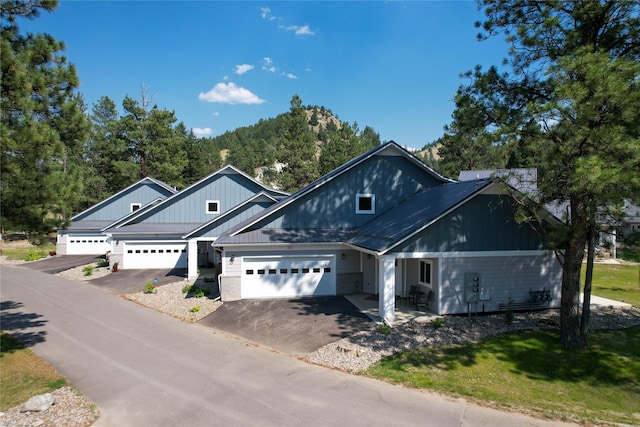 view of front of house featuring a garage and a front lawn