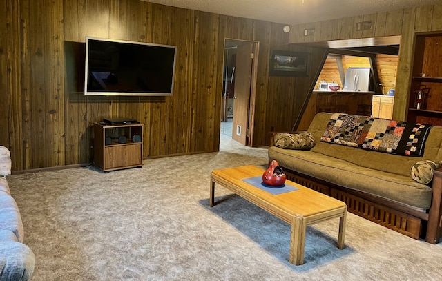 living room featuring a textured ceiling, light colored carpet, and wood walls