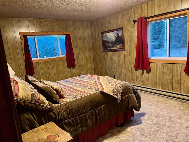 bedroom with a textured ceiling, wooden walls, and carpet floors