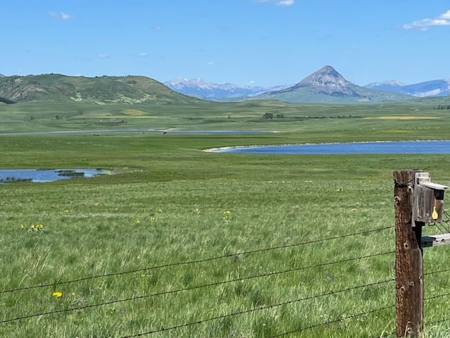 mountain view with a rural view and a water view