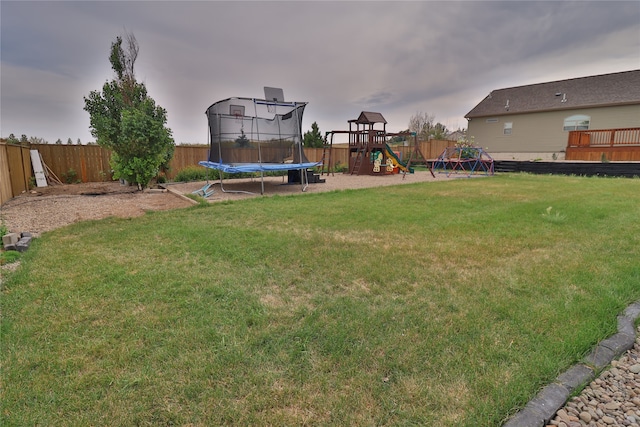 view of yard featuring a playground and a trampoline