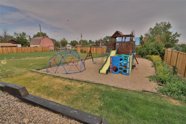 view of playground featuring fence and a lawn