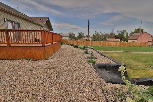 view of yard featuring a deck and fence