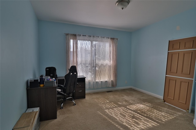 carpeted home office featuring baseboards