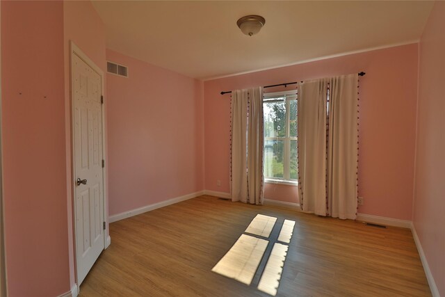 unfurnished room with light hardwood / wood-style floors