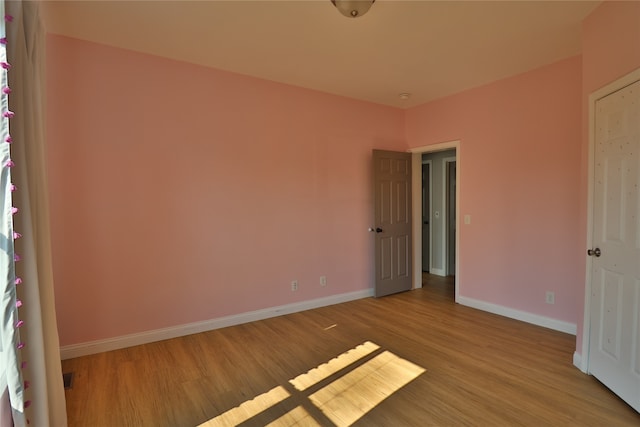 spare room featuring light hardwood / wood-style flooring