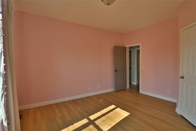 unfurnished bedroom featuring light wood-style flooring and baseboards