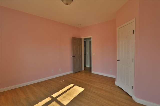 interior space with light wood finished floors and baseboards