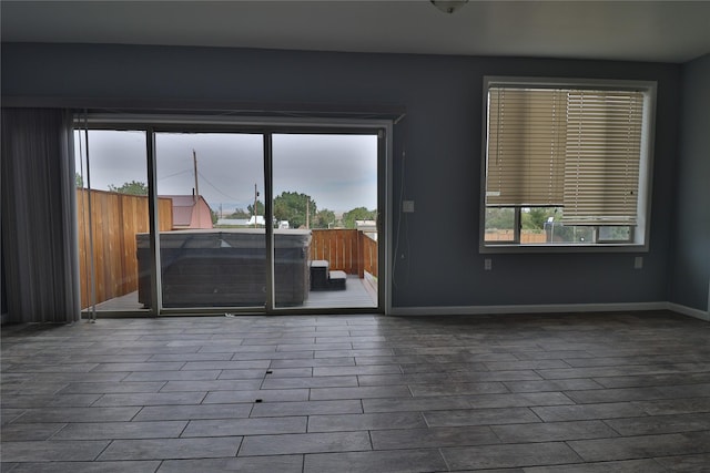 empty room featuring baseboards and wood finished floors