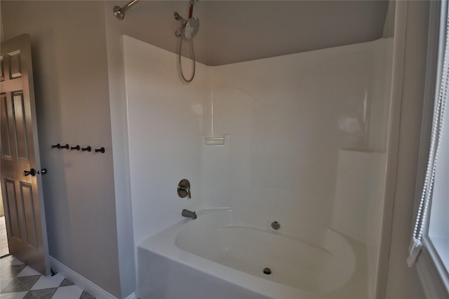 full bath featuring baseboards and shower / bathing tub combination