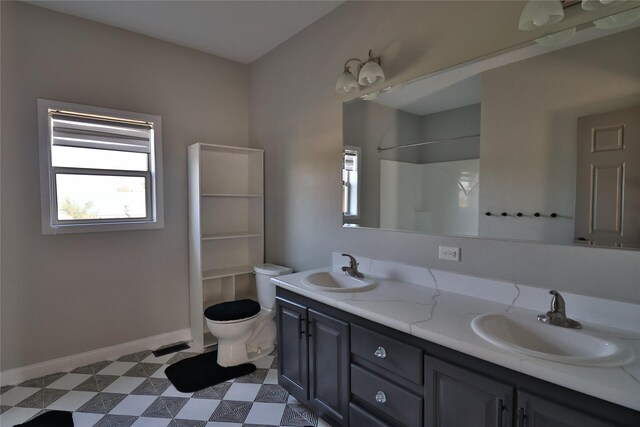 bathroom with vanity, toilet, and a shower