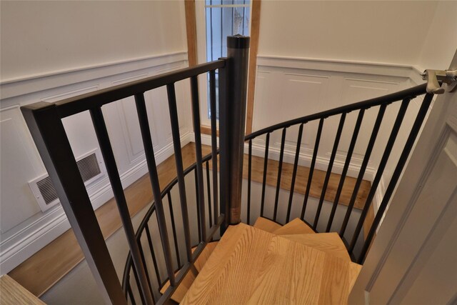 stairway featuring hardwood / wood-style flooring