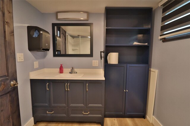 bathroom with hardwood / wood-style flooring and vanity