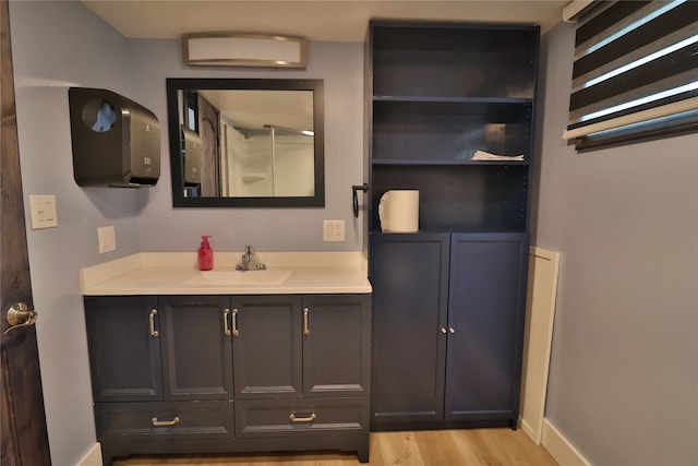 bathroom with hardwood / wood-style flooring and vanity