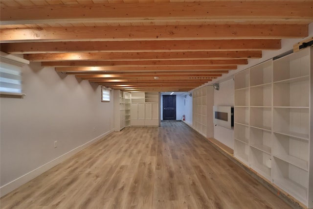 basement with light wood-style floors and baseboards