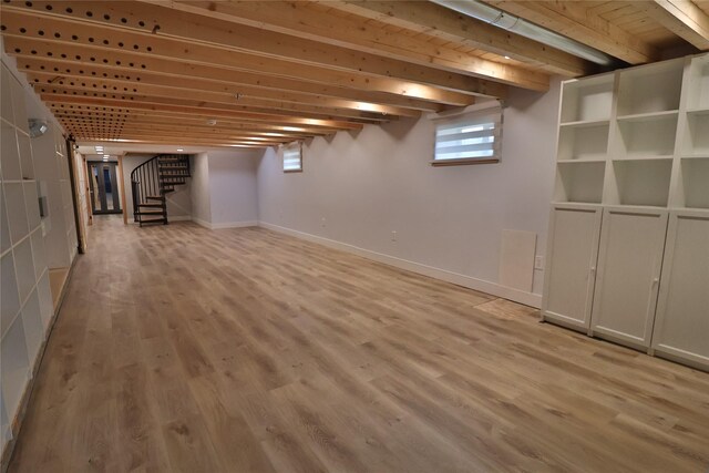 basement with light hardwood / wood-style flooring