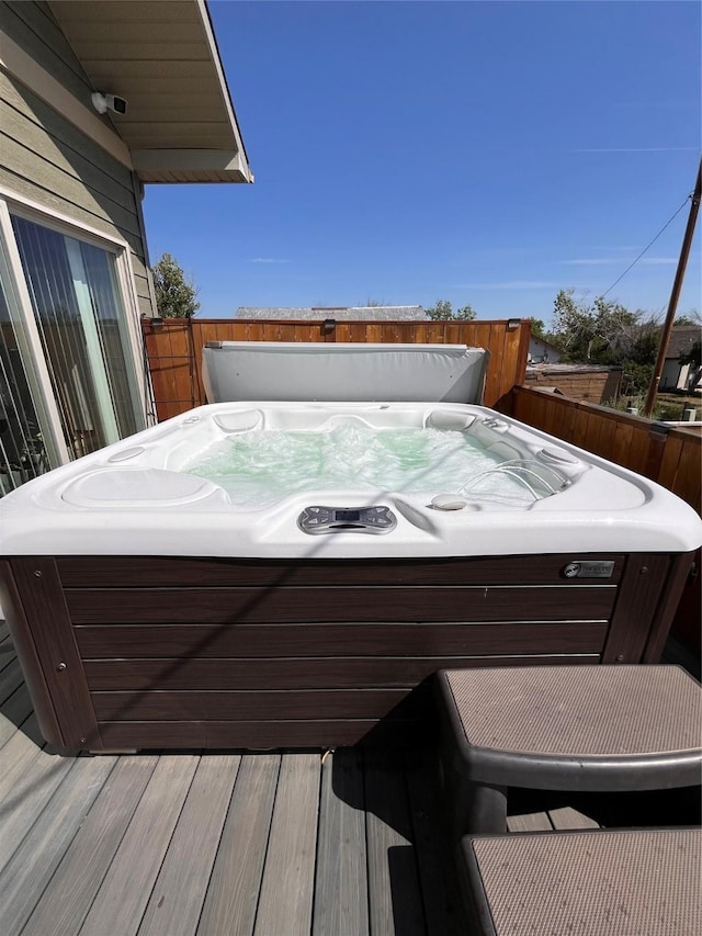 deck with fence and a hot tub