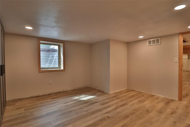 spare room with light hardwood / wood-style flooring