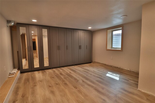 unfurnished bedroom with light wood-type flooring