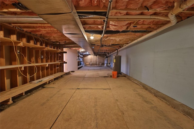 unfinished basement featuring gas water heater