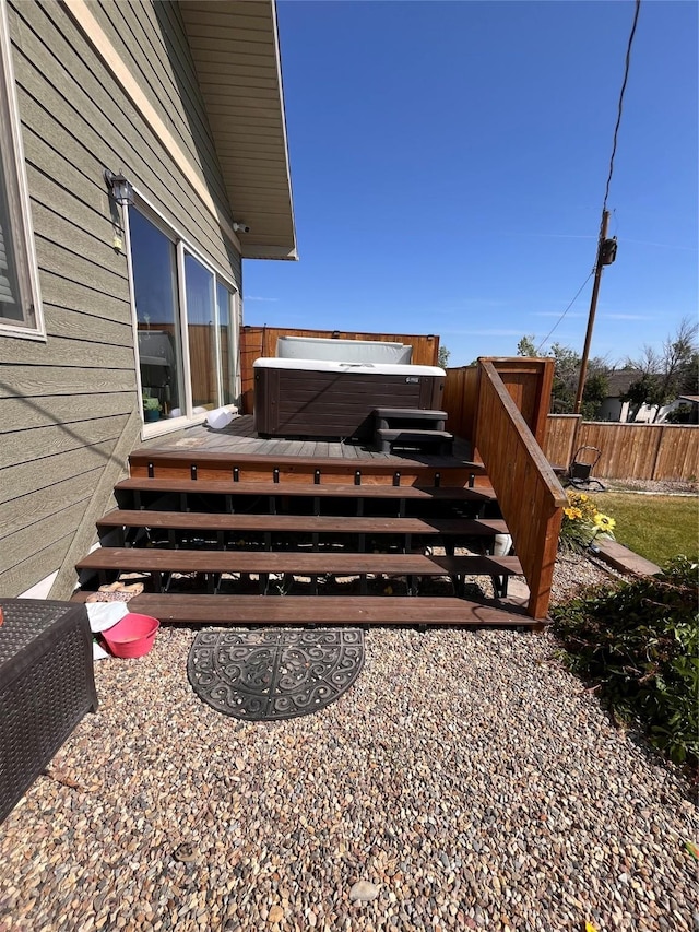 exterior space featuring fence and a hot tub